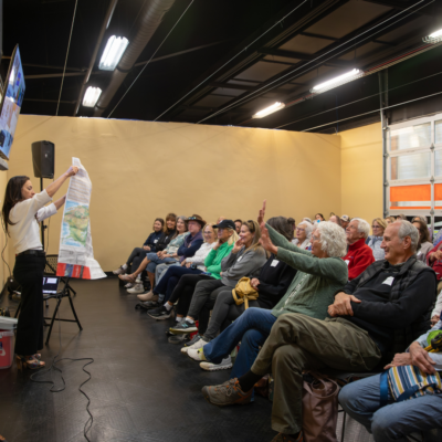 A group of senior citizens in a class room with a spaker at the front