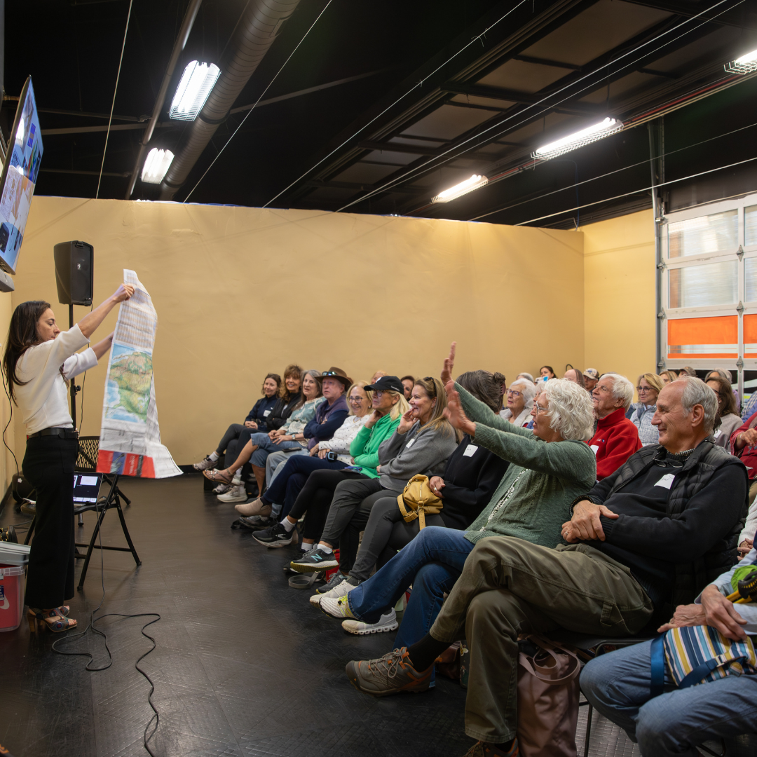 A group of senior citizens in a class room with a spaker at the front